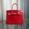 Rose Scheherazade Shiny Porosus Crocodile Birkin 30 Bag Front view of a luxury Birkin 30 bag in Rose Scheherazade shiny Porosus crocodile leather with gold hardware.