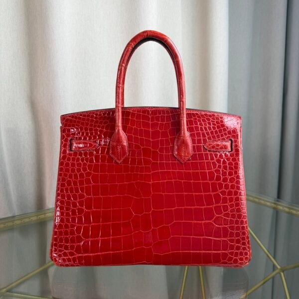 Rose Scheherazade Shiny Porosus Crocodile Birkin 30 Bag Front view of a luxury Birkin 30 bag in Rose Scheherazade shiny Porosus crocodile leather with gold hardware.