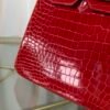 Rose Scheherazade Shiny Porosus Crocodile Birkin 30 Bag Front view of a luxury Birkin 30 bag in Rose Scheherazade shiny Porosus crocodile leather with gold hardware.