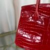 Rose Scheherazade Shiny Porosus Crocodile Birkin 30 Bag Front view of a luxury Birkin 30 bag in Rose Scheherazade shiny Porosus crocodile leather with gold hardware.