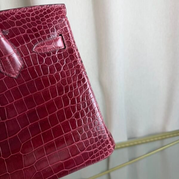 Bordeaux Shiny Niloticus Crocodile Birkin 30 Bag Front view of a luxury Birkin 30 bag in Bordeaux shiny Niloticus crocodile leather with gold hardware.