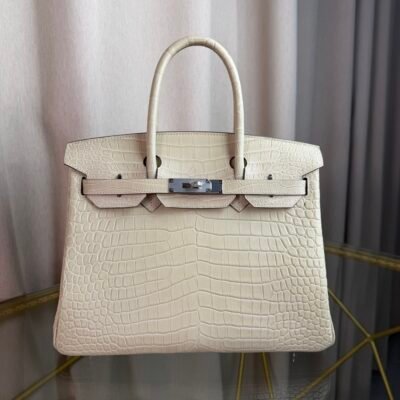 Glacier White Matte Alligator Birkin 30 Bag Front view of a luxury Birkin 30 bag in Glacier White matte Alligator leather with palladium hardware.