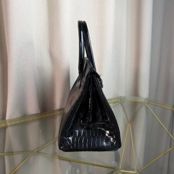 Black Shiny Niloticus Crocodile Birkin 30 Bag Front view of a luxury Birkin 30 bag in Black shiny Niloticus crocodile leather with palladium hardware.