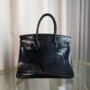 Black Shiny Niloticus Crocodile Birkin 30 Bag Front view of a luxury Birkin 30 bag in Black shiny Niloticus crocodile leather with palladium hardware.