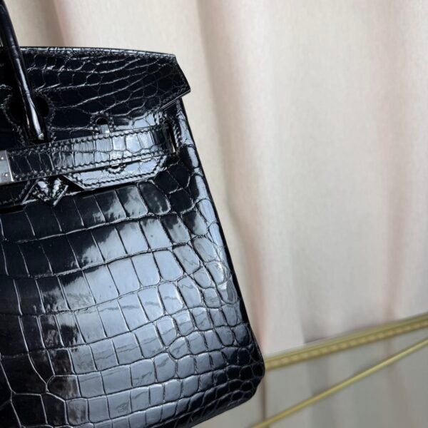 Black Shiny Niloticus Crocodile Birkin 30 Bag Front view of a luxury Birkin 30 bag in Black shiny Niloticus crocodile leather with palladium hardware.