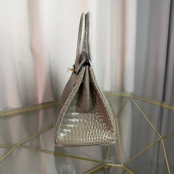Gris Tourterelle Shiny Porosus Crocodile Birkin 30 Bag Front view of a luxury Birkin 30 bag in Gris Tourterelle shiny Porosus crocodile leather with gold hardware.
