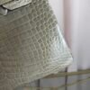Gris Tourterelle Shiny Porosus Crocodile Birkin 30 Bag Front view of a luxury Birkin 30 bag in Gris Tourterelle shiny Porosus crocodile leather with gold hardware.