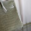 Gris Tourterelle Shiny Porosus Crocodile Birkin 30 Bag Front view of a luxury Birkin 30 bag in Gris Tourterelle shiny Porosus crocodile leather with gold hardware.