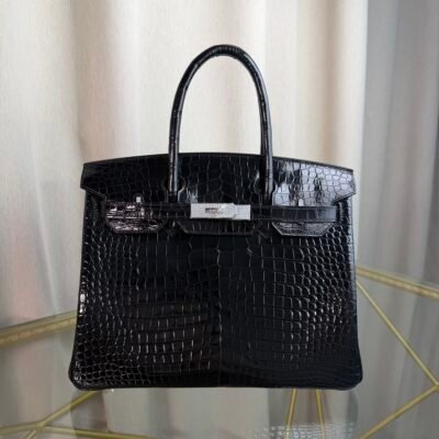 Black Shiny Porosus Crocodile Birkin 35 Diamond Hardware Bag Front view of an ultra-luxury Birkin 35 bag in Black shiny Porosus crocodile leather with 18k white gold diamond hardware.