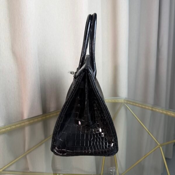 Black Shiny Porosus Crocodile Birkin 35 Diamond Hardware Bag Front view of an ultra-luxury Birkin 35 bag in Black shiny Porosus crocodile leather with 18k white gold diamond hardware.