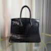 Black Shiny Porosus Crocodile Birkin 35 Diamond Hardware Bag Front view of an ultra-luxury Birkin 35 bag in Black shiny Porosus crocodile leather with 18k white gold diamond hardware.