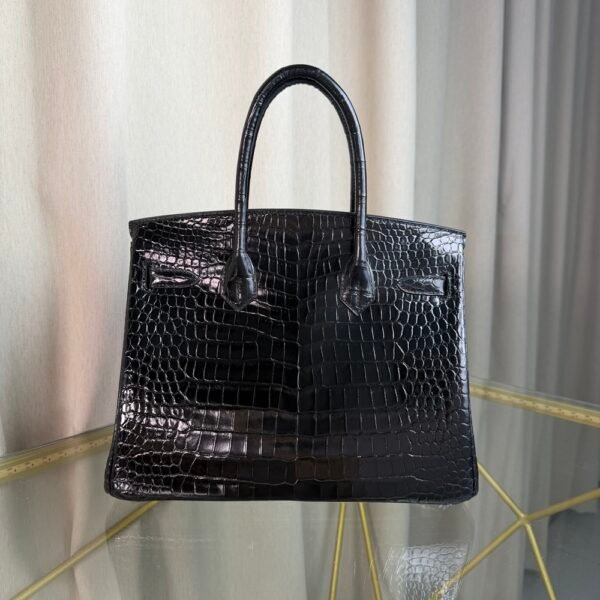 Black Shiny Porosus Crocodile Birkin 35 Diamond Hardware Bag Front view of an ultra-luxury Birkin 35 bag in Black shiny Porosus crocodile leather with 18k white gold diamond hardware.