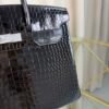Black Shiny Porosus Crocodile Birkin 35 Diamond Hardware Bag Front view of an ultra-luxury Birkin 35 bag in Black shiny Porosus crocodile leather with 18k white gold diamond hardware.