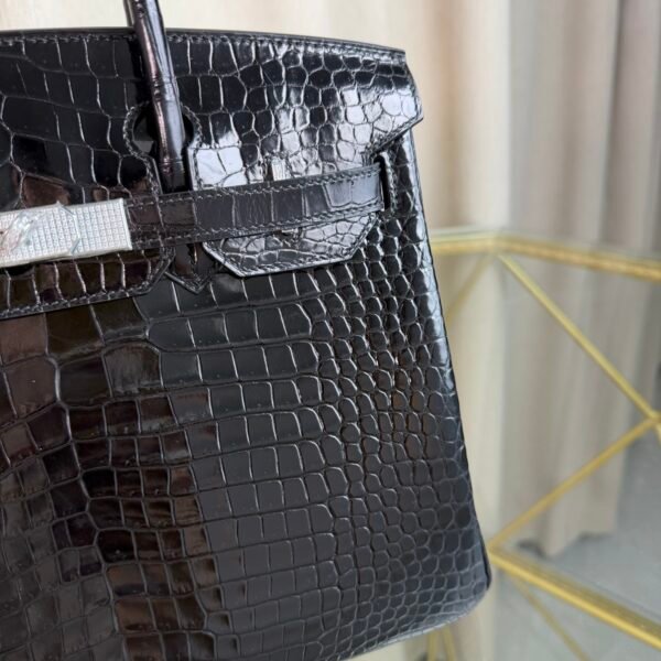 Black Shiny Porosus Crocodile Birkin 35 Diamond Hardware Bag Front view of an ultra-luxury Birkin 35 bag in Black shiny Porosus crocodile leather with 18k white gold diamond hardware.