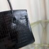 Black Shiny Porosus Crocodile Birkin 35 Diamond Hardware Bag Front view of an ultra-luxury Birkin 35 bag in Black shiny Porosus crocodile leather with 18k white gold diamond hardware.