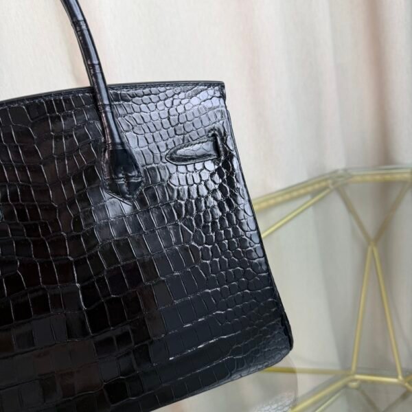 Black Shiny Porosus Crocodile Birkin 35 Diamond Hardware Bag Front view of an ultra-luxury Birkin 35 bag in Black shiny Porosus crocodile leather with 18k white gold diamond hardware.
