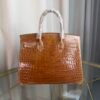 Miel Shiny Niloticus Crocodile Birkin 30 Bag Front view of a luxury Birkin 30 bag in Miel shiny Niloticus crocodile leather with palladium hardware.