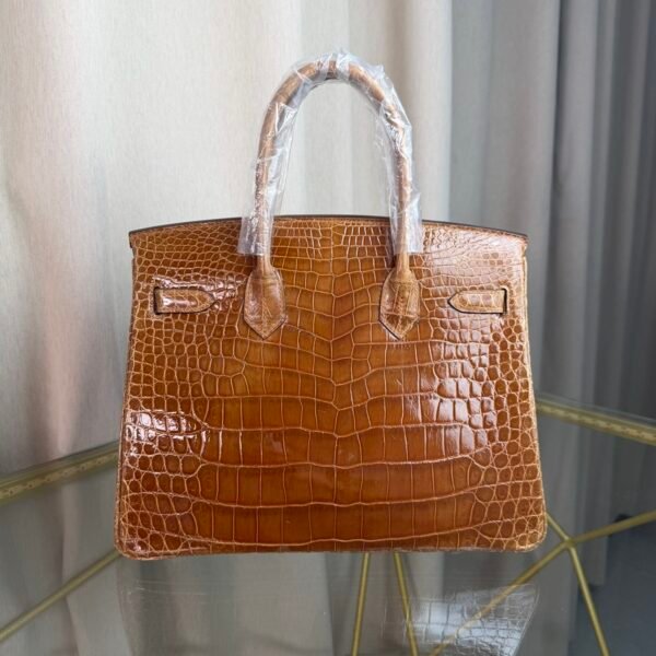 Miel Shiny Niloticus Crocodile Birkin 30 Bag Front view of a luxury Birkin 30 bag in Miel shiny Niloticus crocodile leather with palladium hardware.