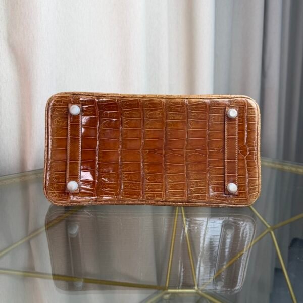 Miel Shiny Niloticus Crocodile Birkin 30 Bag Front view of a luxury Birkin 30 bag in Miel shiny Niloticus crocodile leather with palladium hardware.