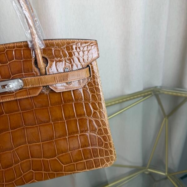 Miel Shiny Niloticus Crocodile Birkin 30 Bag Front view of a luxury Birkin 30 bag in Miel shiny Niloticus crocodile leather with palladium hardware.
