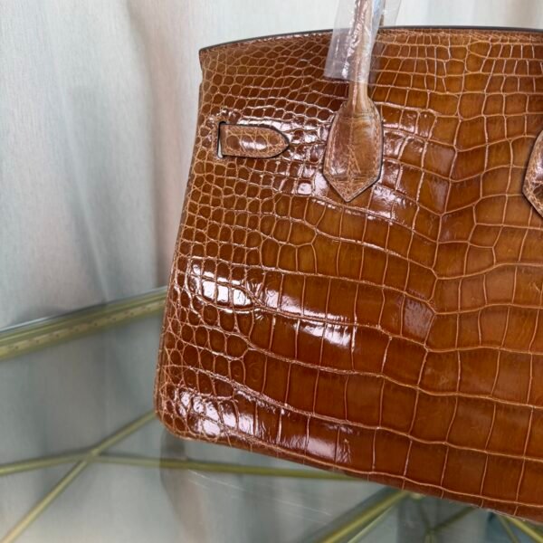 Miel Shiny Niloticus Crocodile Birkin 30 Bag Front view of a luxury Birkin 30 bag in Miel shiny Niloticus crocodile leather with palladium hardware.