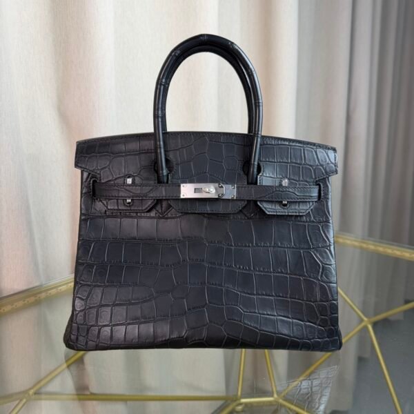 Black Matte Niloticus Crocodile Birkin 30 Bag Front view of a luxury Birkin 30 bag in Black matte Niloticus crocodile leather with palladium hardware.