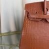 Gold Matte Niloticus Crocodile Birkin 30 Bag Front view of a luxury Birkin 30 bag in Gold matte Niloticus crocodile leather with gold hardware.